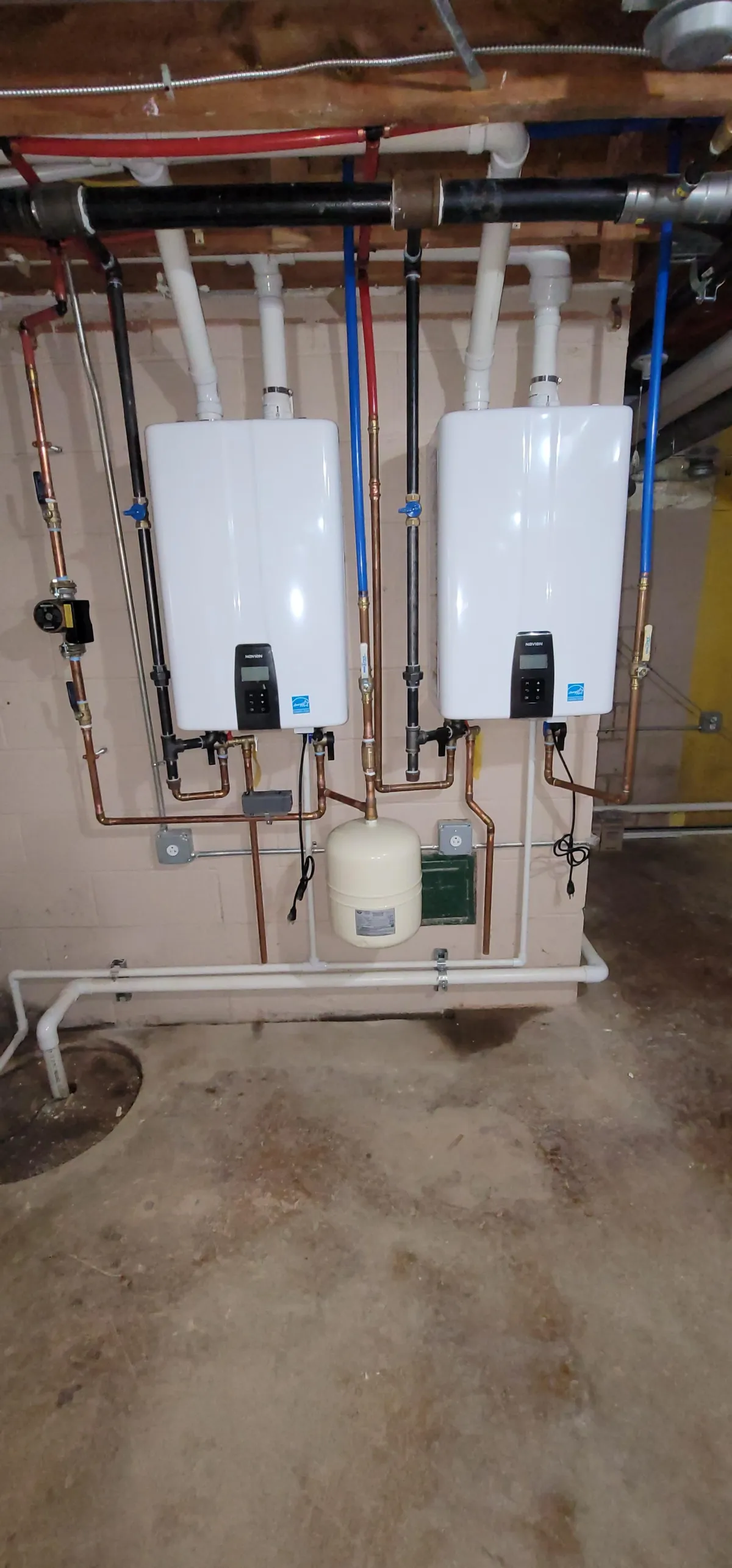 A professionally installed tankless water heater by Hatz Plumbing, showcasing the compact design and advanced technology that provides endless hot water with energy efficiency.