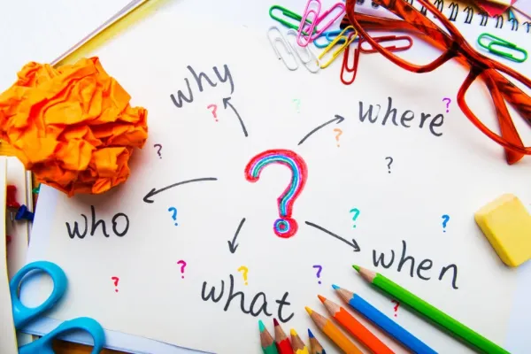 colourful marker or crayon drawn question mark with questions why, where, who, what, when around it