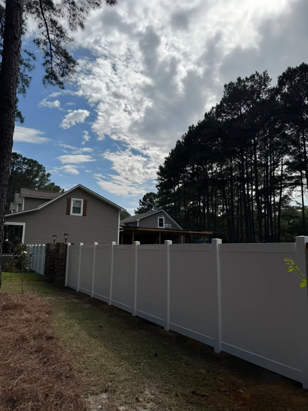 Tall white vinyl privacy fence ensuring residential security, MCM Fence LLC installation in Lee County, GA.