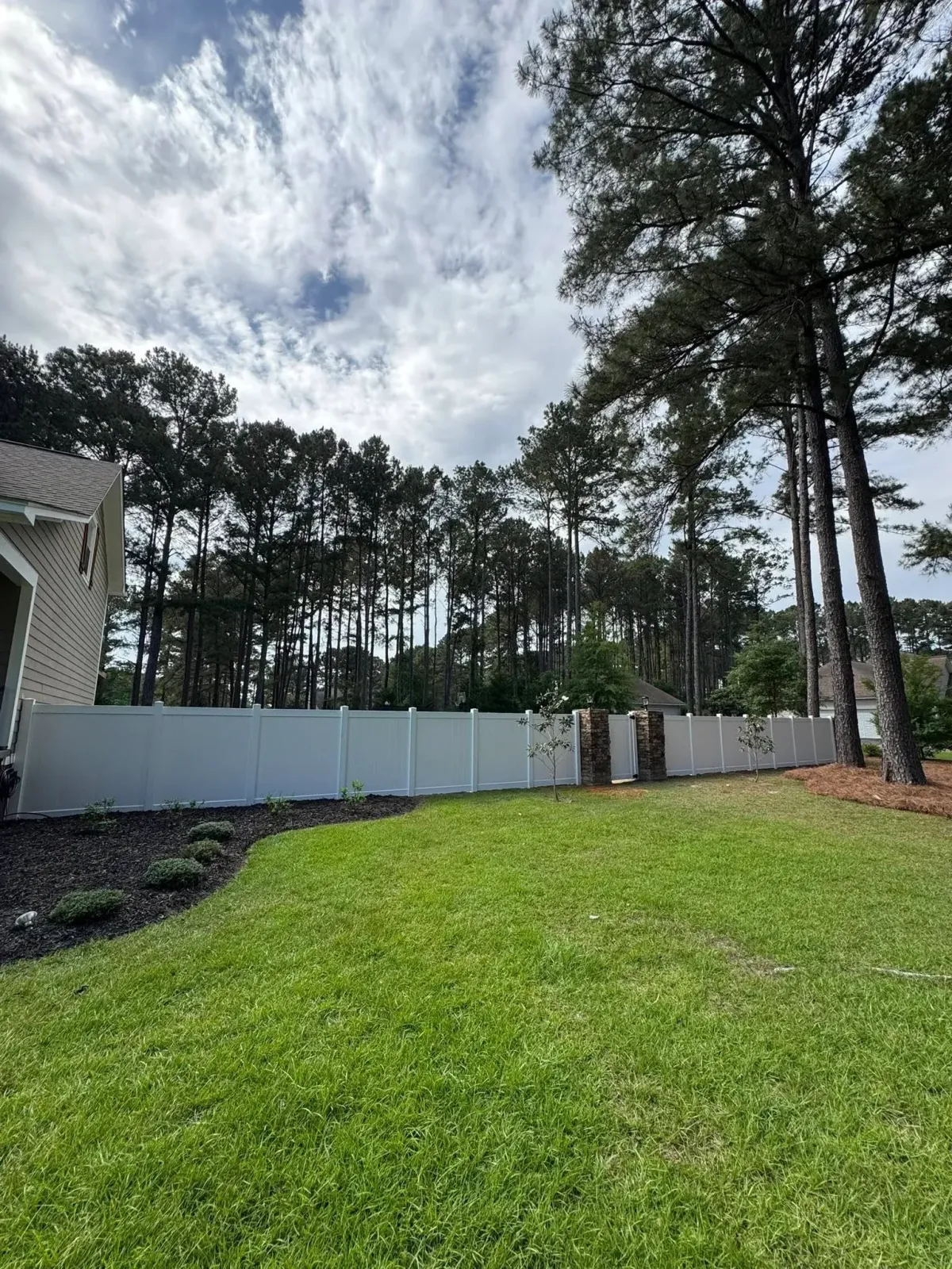 White vinyl privacy fence providing backyard seclusion, installed by MCM Fence LLC in Albany, GA.
