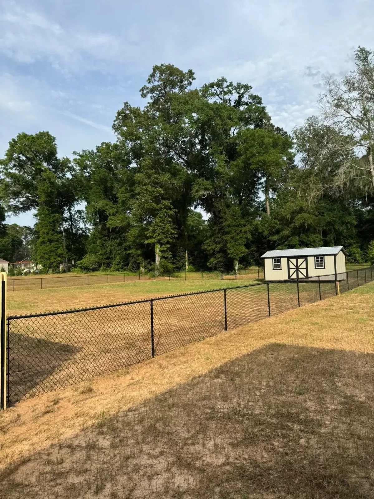 Expansive black chain link fencing for large property or farm, by MCM Fence LLC in Tifton, GA.