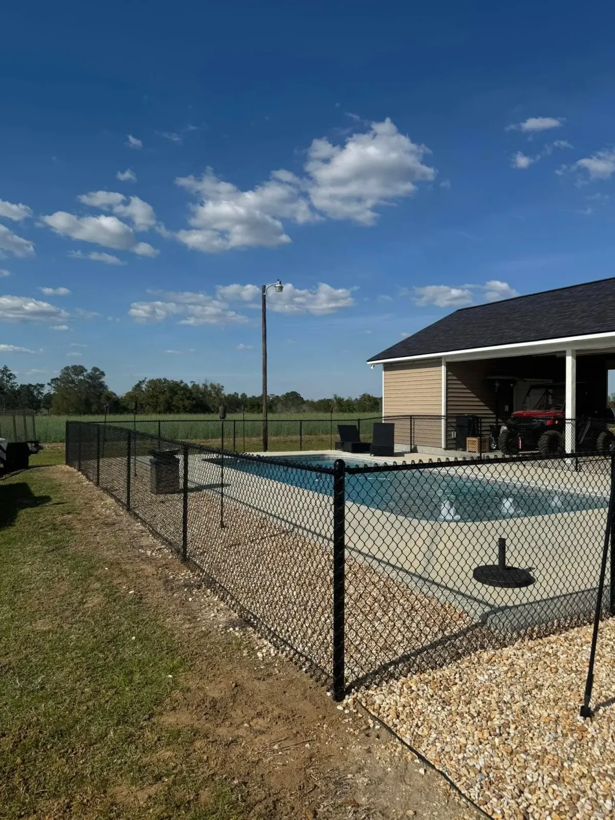 Secure black chain link pool safety fence installed by MCM Fence LLC in Albany, GA.