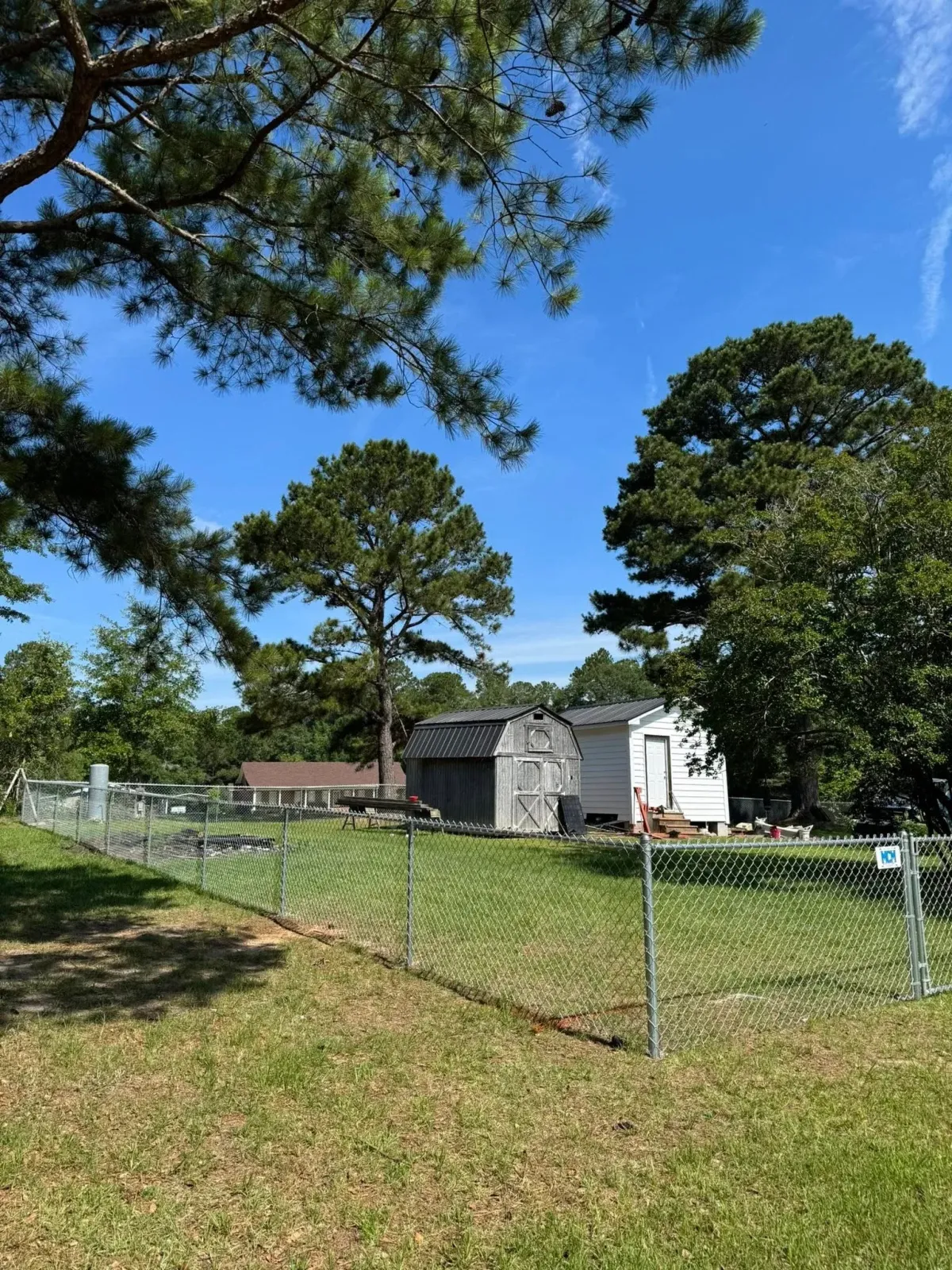Galvanized chain link fence securing property with shed, MCM Fence LLC project in Tifton, GA.
