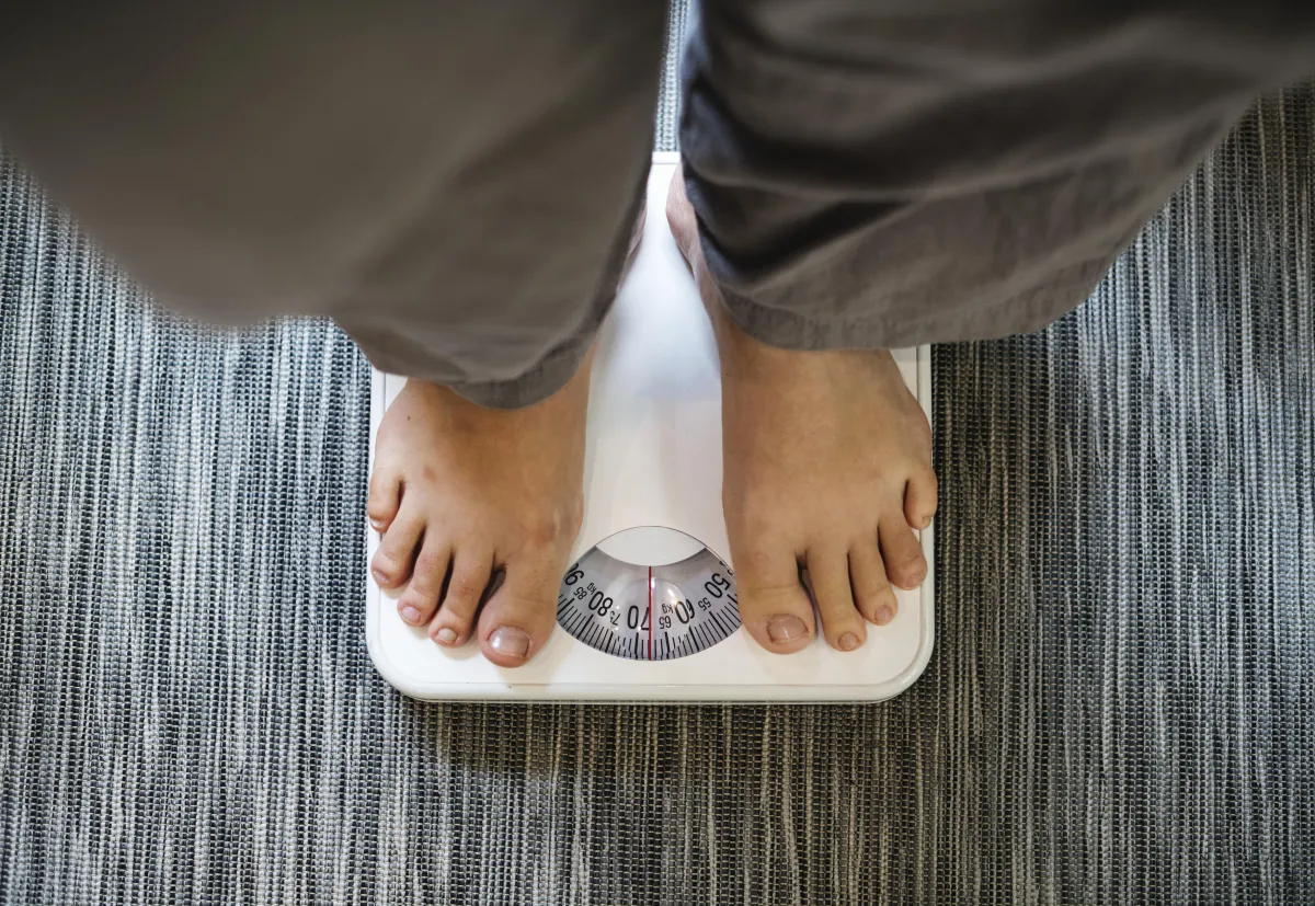 Person standing on a scale, representing the daily weigh-in ritual of the Hyper-Ketosis Challenge—a key habit for accountability, tracking progress, and staying motivated throughout the 24-day transformation