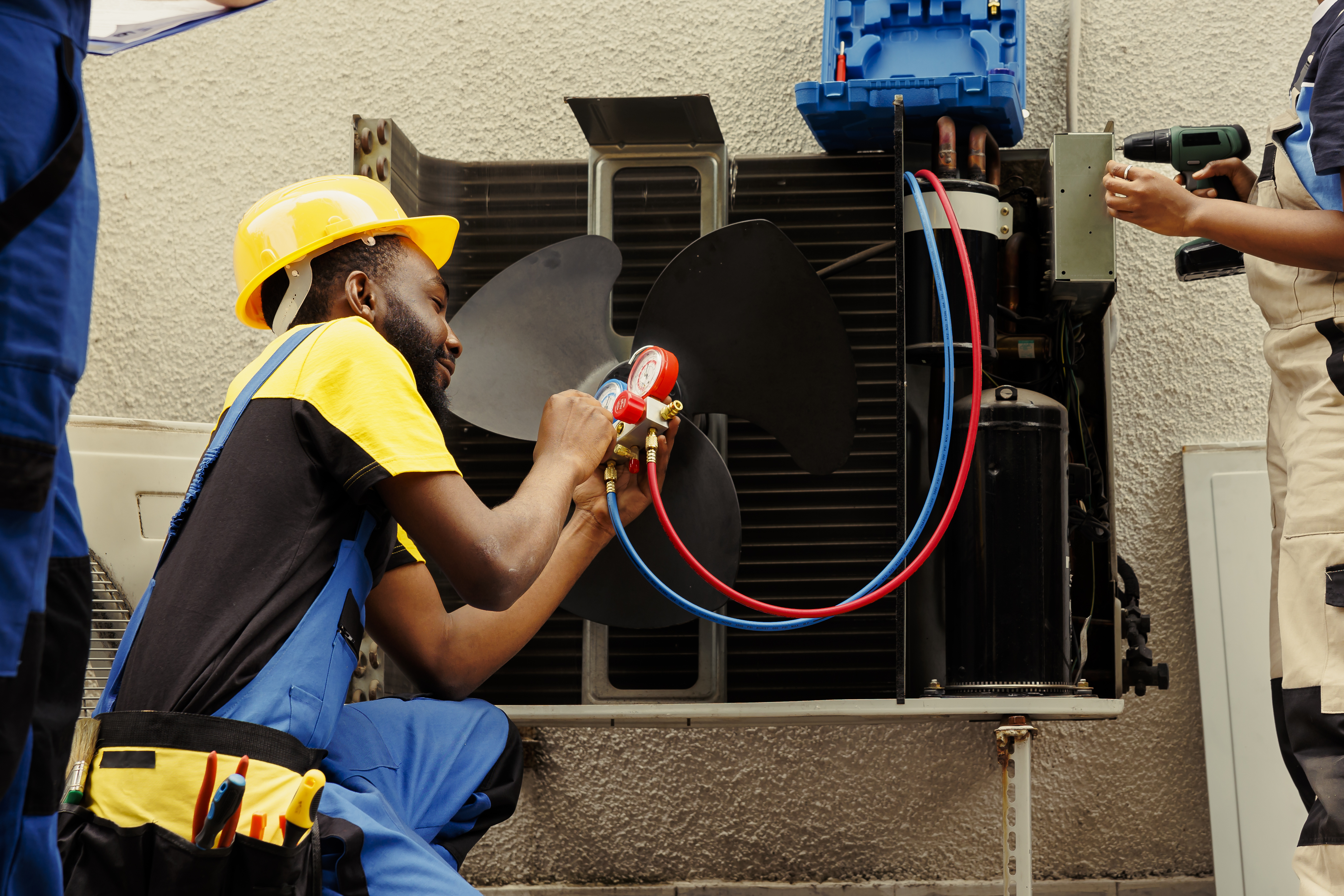 Worker refilling hvac system refrigerant