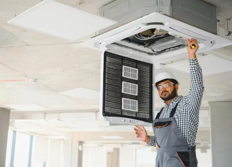 An HVAC Contractor fixing an AC
