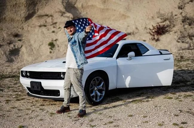 Man with car outdoors preparing to sell — showing how to correct title issues or errors before selling your vehicle.