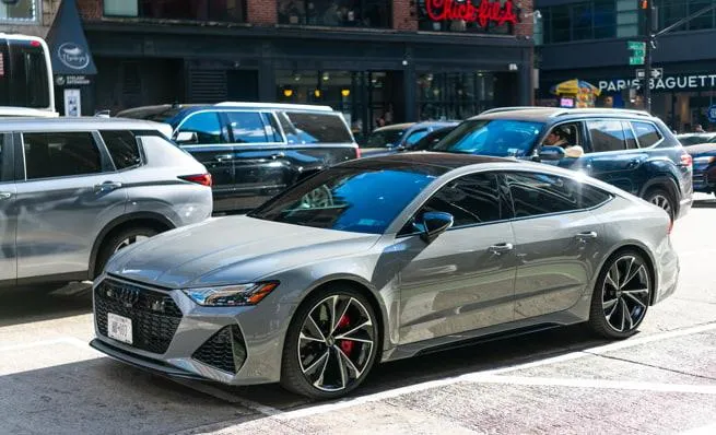 Modern gray car parked in downtown Illinois — visual reference for real cost of tax, title, and license fees on new cars.