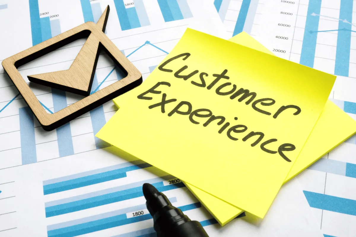 An image of a business card with the words 'Customer Experience' printed on it, symbolizing the importance of delivering excellent service in the digital era."