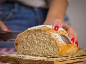 woman slicing sourdough