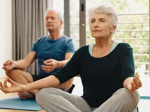 older couple meditating