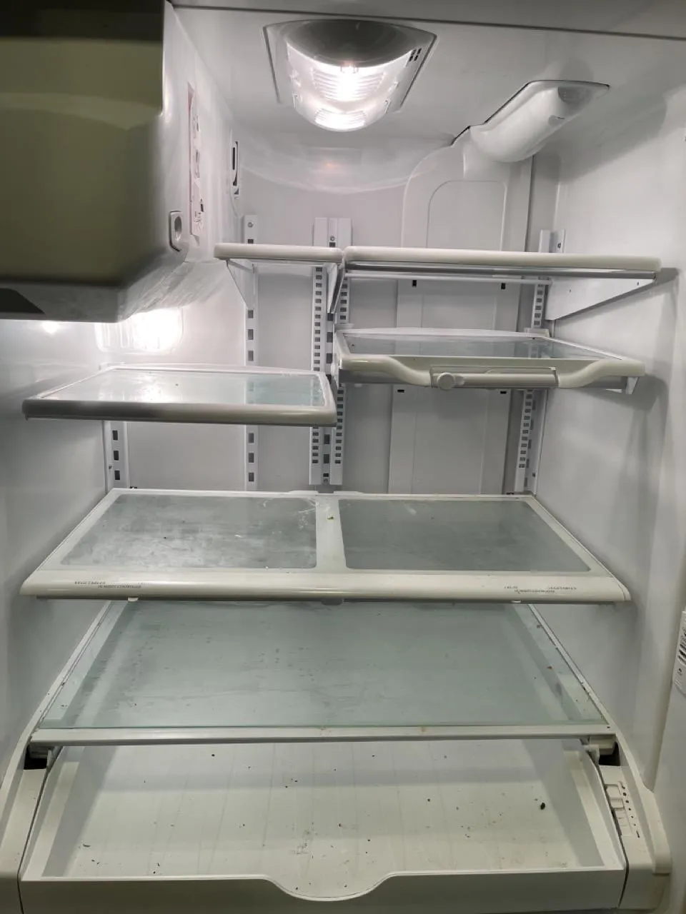 Plainfield refrigerator interior showing dirt and food residue before cleaning.
