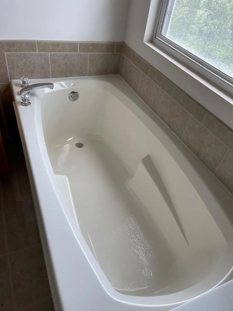 Sparkling clean bathtub in a Lemont home after post-construction cleaning.
