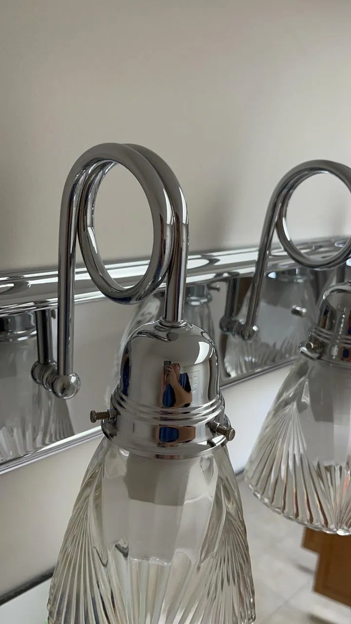 Clean and shiny bathroom light fixture in a Darien home after deep cleaning.