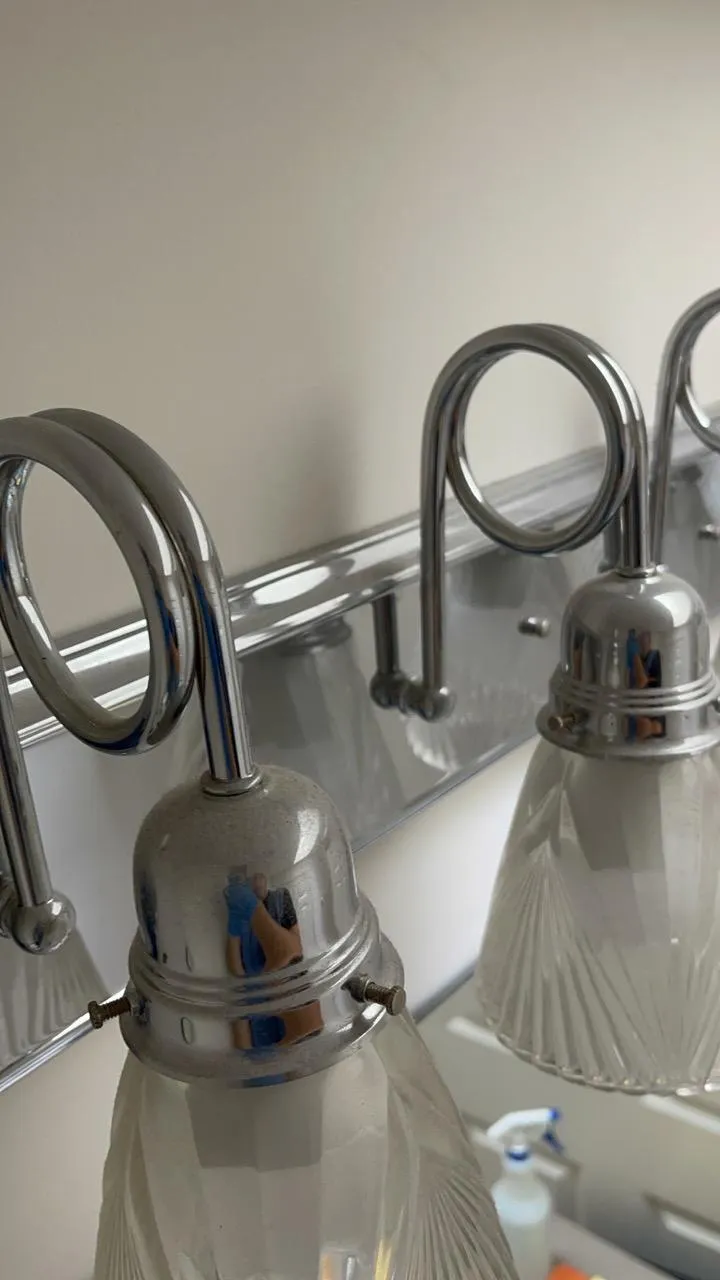 Dusty bathroom light fixture in a Darien home before deep cleaning.