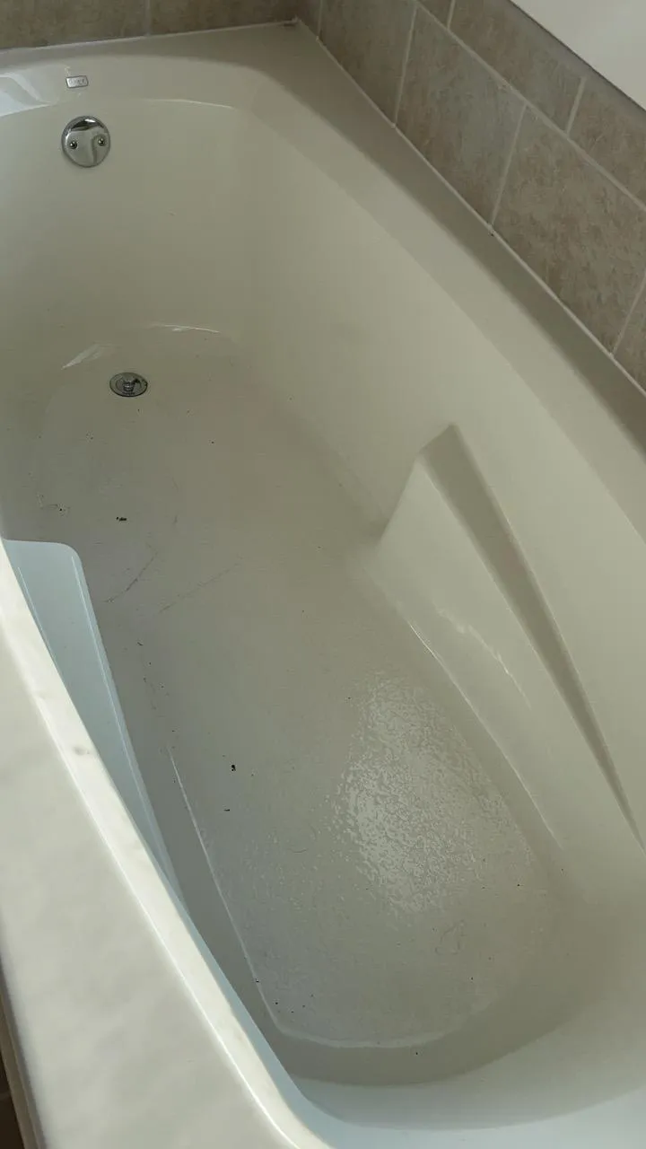 Dusty and dirty bathtub in Lemont after construction work, before cleaning.