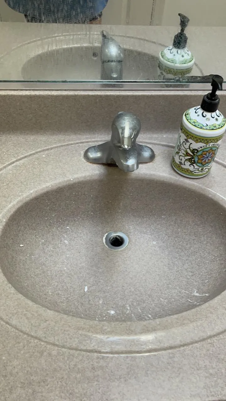 Dirty bathroom sink and faucet in a Woodridge home before cleaning.