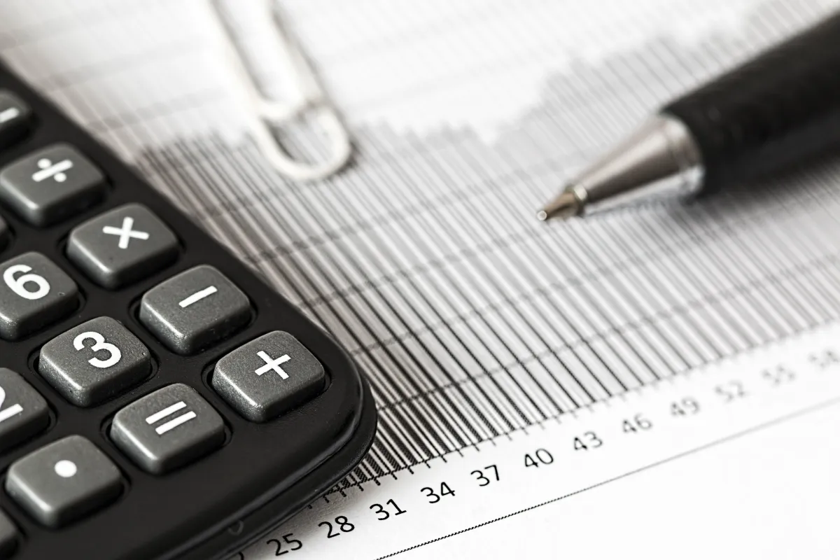 A picture of a piece of paper and calculator and pen 