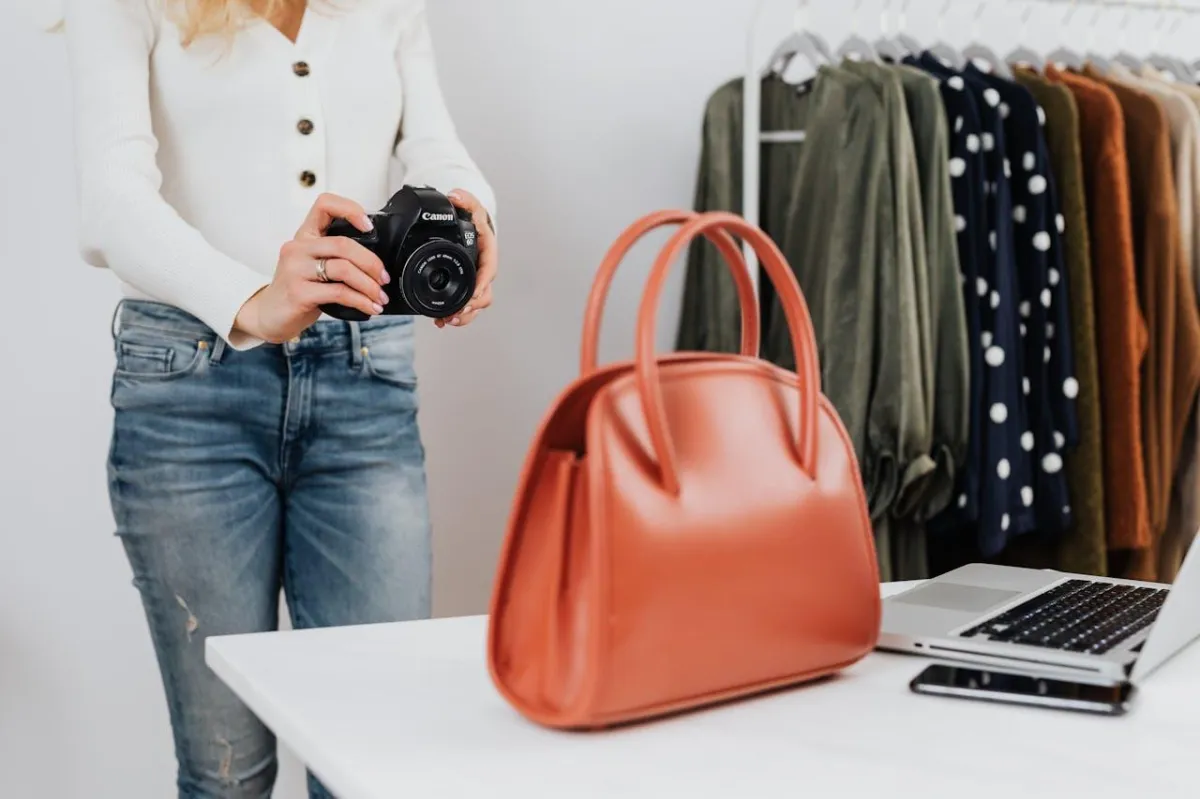 woman taking picture of a bag