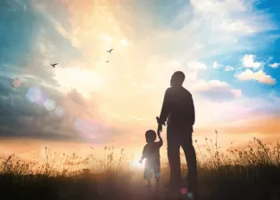 Father and child look into beautiful sky