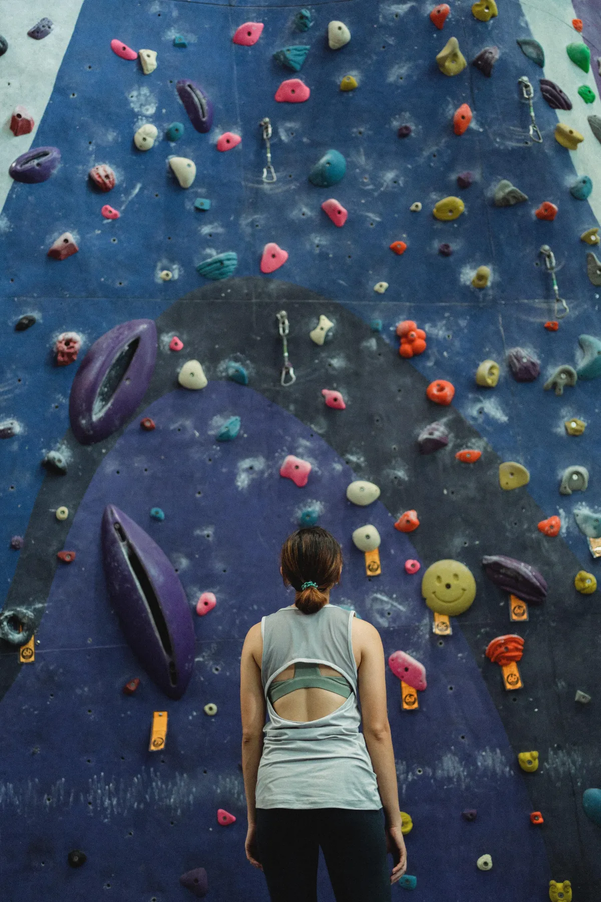 woman looking at climbing wall