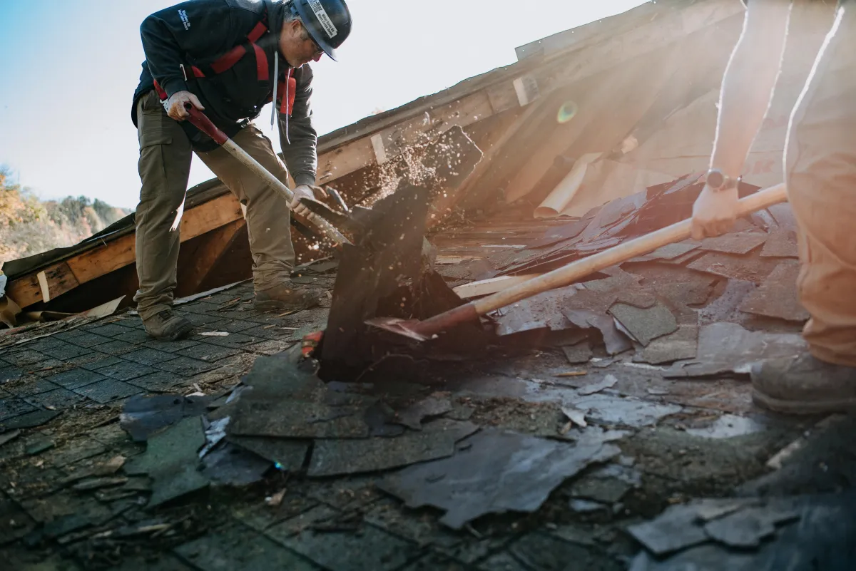 Men clearing the roof of fire debris