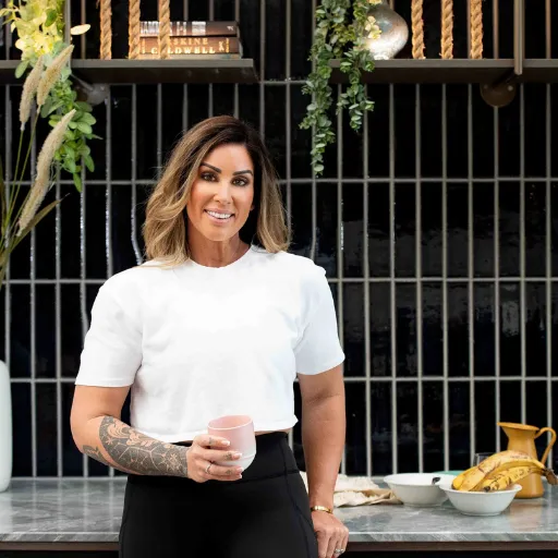 Health coach standing in kitchen