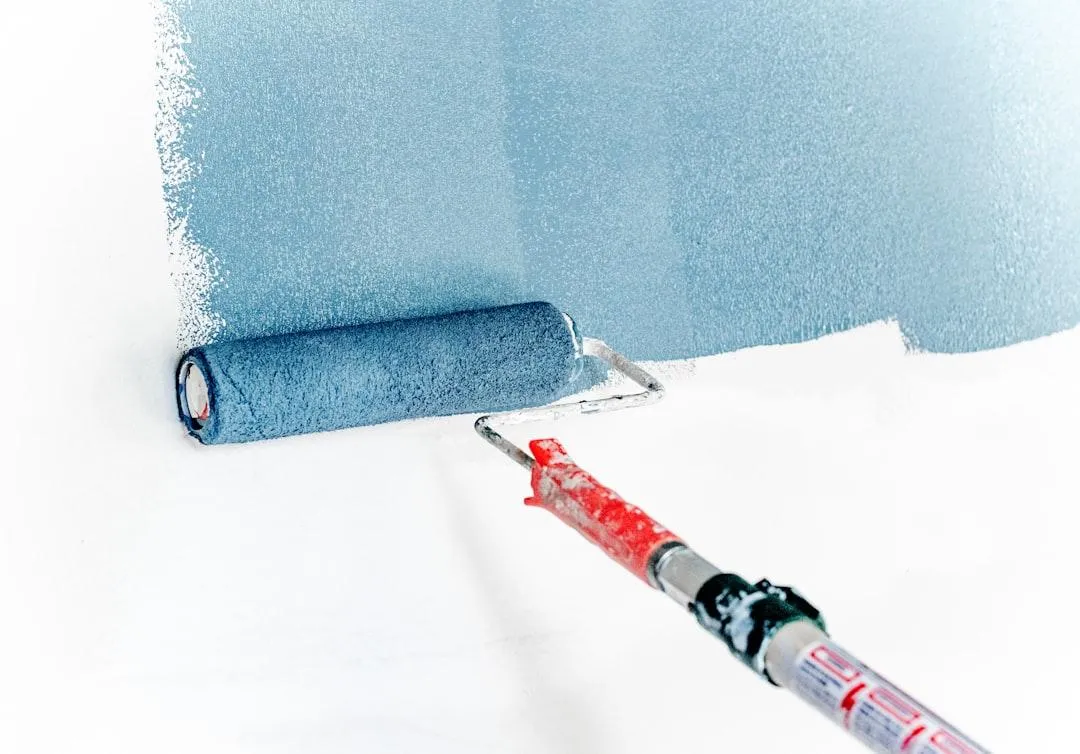 Paint roller applying paint over a properly prepared surface.