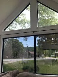 Professional installer applying window film to sitting room windows
