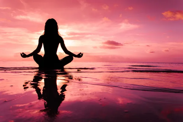 A visually stunning image that represents the mind-body connection, perhaps showing a person practicing yoga or meditation in a serene setting.