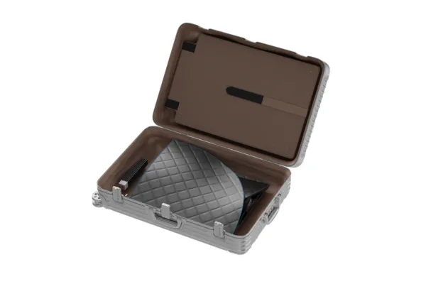 A clean, visually appealing image that powerfully emphasizes the compact size of the Mobile Wellness sauna. This could be the folded sauna in its carry-on bag placed next to a single pair of shoes and a passport, showcasing a minimalist travel setup.