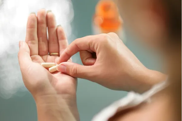An image of vitamin supplements in a hand.