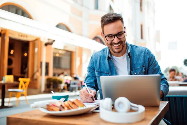 A man sitting at a table on his computer