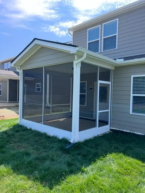 Custom aluminum frame screen porch with white trim and grassy lawn in Tennessee
