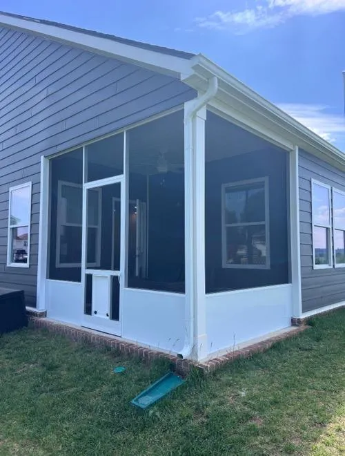 Custom screen porch with gray siding and white trim on a Tennessee home