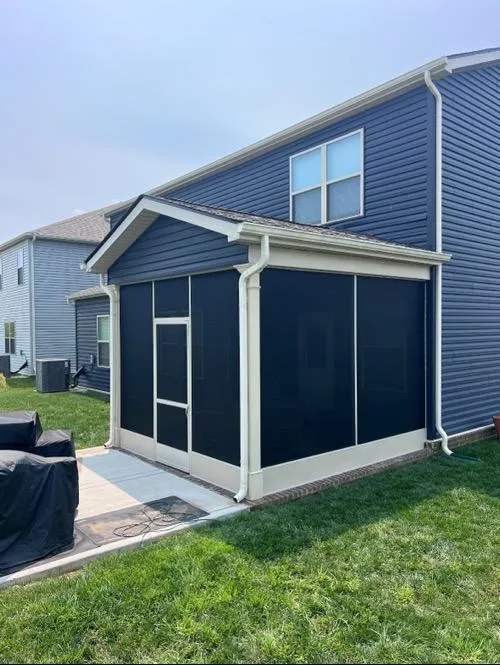 Custom screen porch with black mesh and beige trim on a Tennessee home