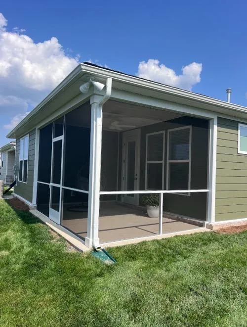 Custom screen porch with green siding and white trim on a Tennessee home
