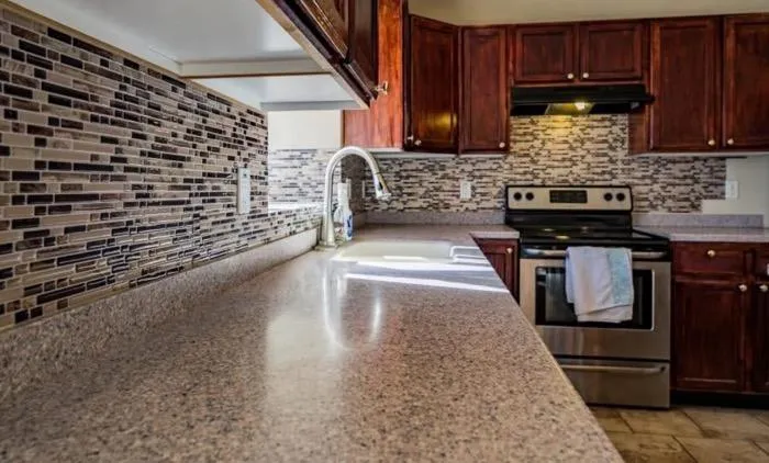 Modern kitchen with tile backsplash and wood cabinets.