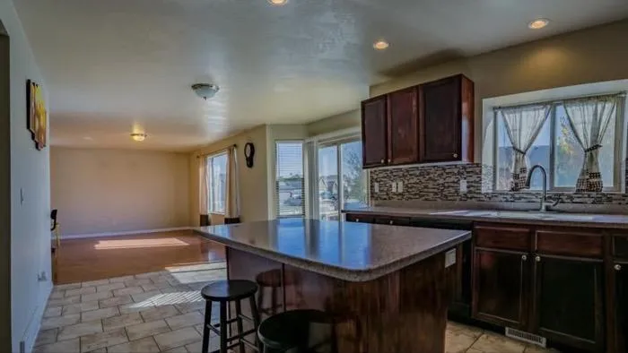 Kitchen with island and open dining area in Ogden home.