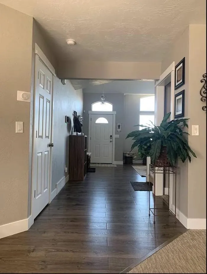Entryway remodel with hardwood flooring and neutral walls in Roy UT