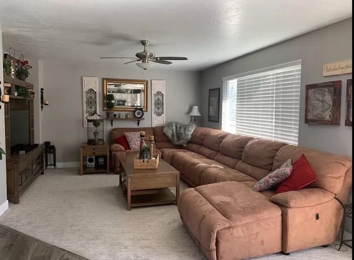 Cozy living room remodel with sectional sofa and neutral walls in Roy UT