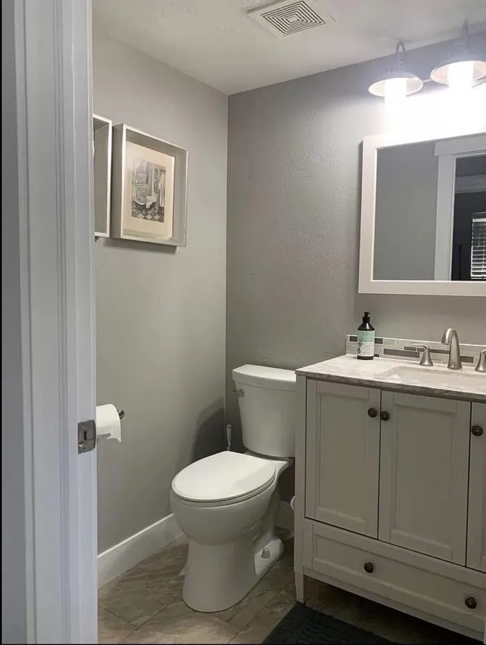 Small bathroom remodel with white vanity and modern lighting in Kaysville UT