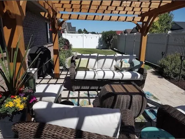 Cozy outdoor deck with pergola and wicker furniture in Farr West UT