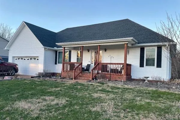 White vinyl siding home with front porch renovation in Spring Hill, Tennessee