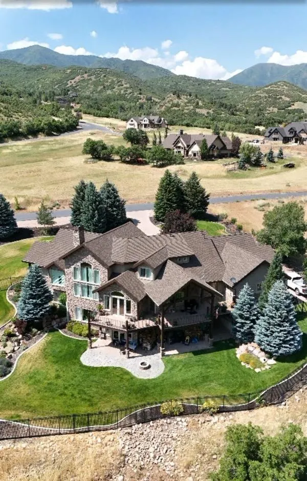 Aerial view of custom home with new roof in Alpine, Utah.