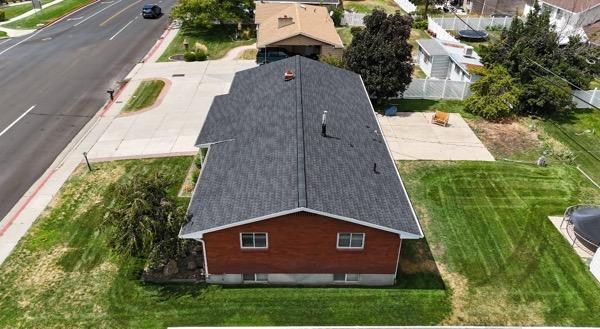 Aerial view of roof replacement on brick home in Springville, Utah.