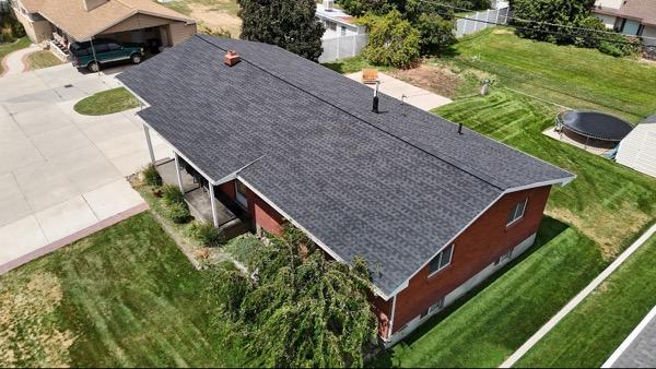 Aerial view of new asphalt shingle roof on home in Springville, Utah.