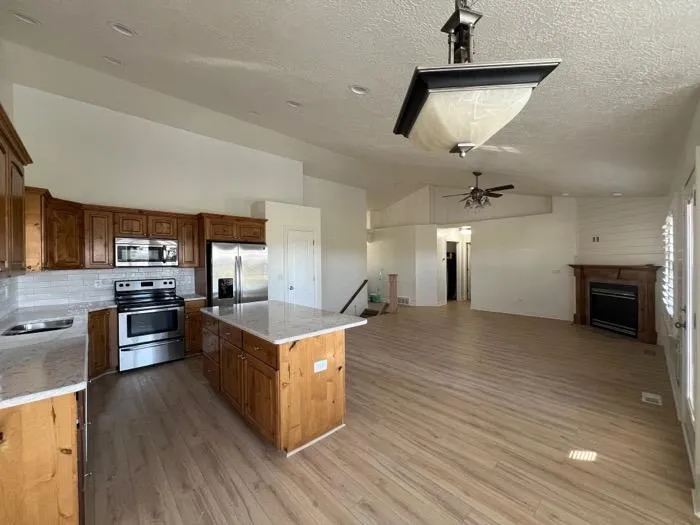 Kitchen island remodel with wooden cabinets and gray countertop in Bountiful UT