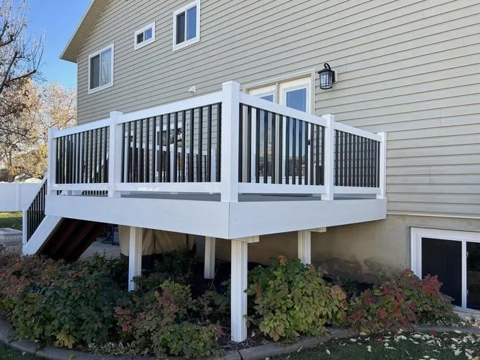 Modern basement kitchenette with gray cabinets and granite countertop in Ogden UT