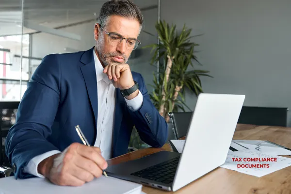 Business owner reviewing tax compliance documents